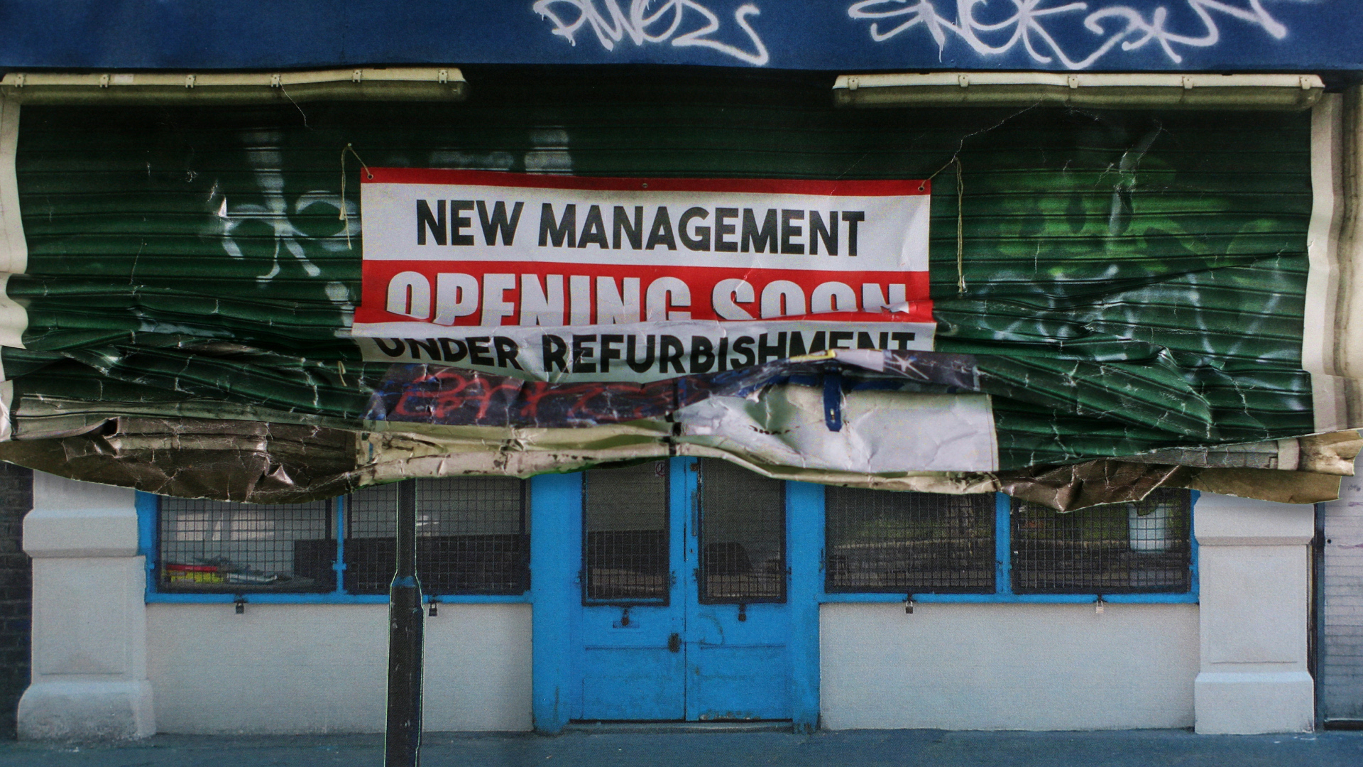 A photo of a shop front with a blue door with another photo of a green shop front half over it