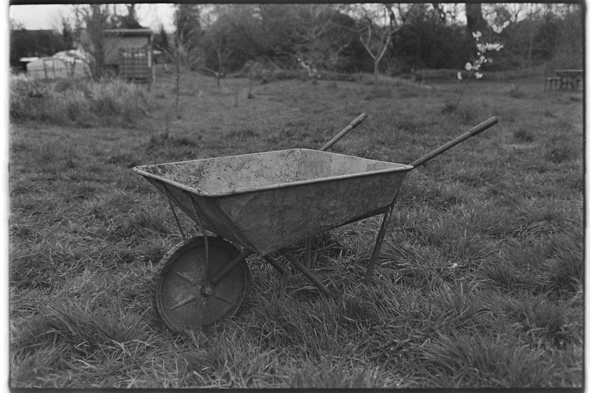 A black and white photograph of a wheelbarrow