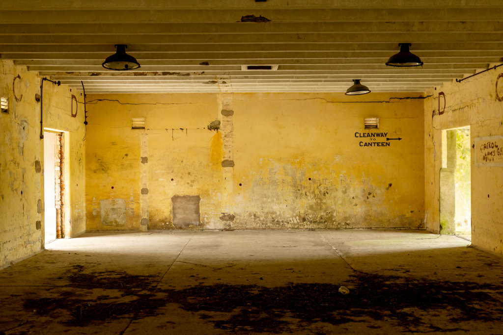 Large empty industrial space with yellow walls