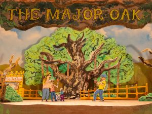 A toy theatre style cut out drawing of a tree, with four cut out figures, and the heading The Major Oak