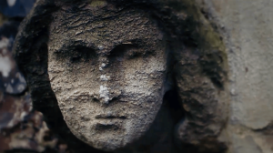 A woman's face carved in stone.